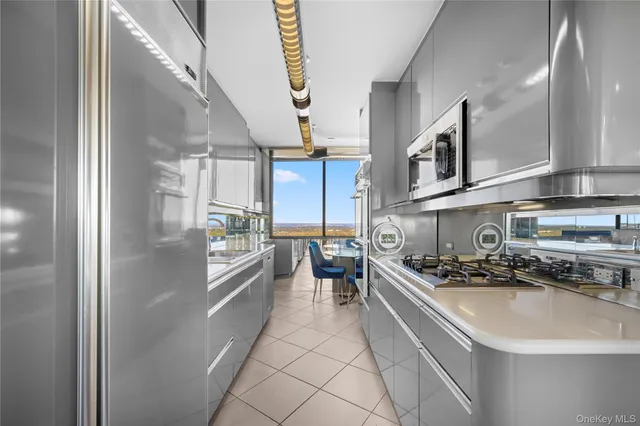 a kitchen with a refrigerator and a stove