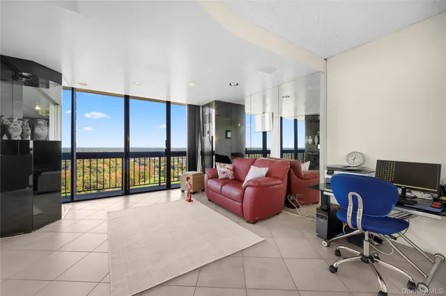 a living room with furniture a dining table and a piano