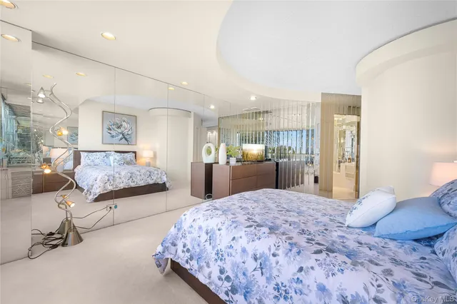 a living room with furniture and a painting on the wall