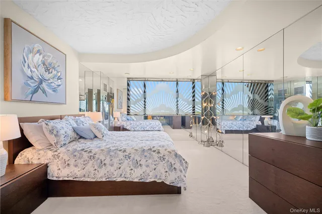 a bathroom with a tub a sink and a large mirror