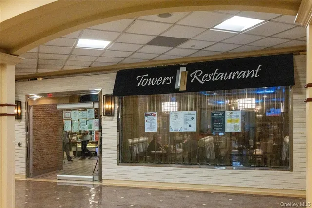 a view of a hallway with wooden floor and dining room