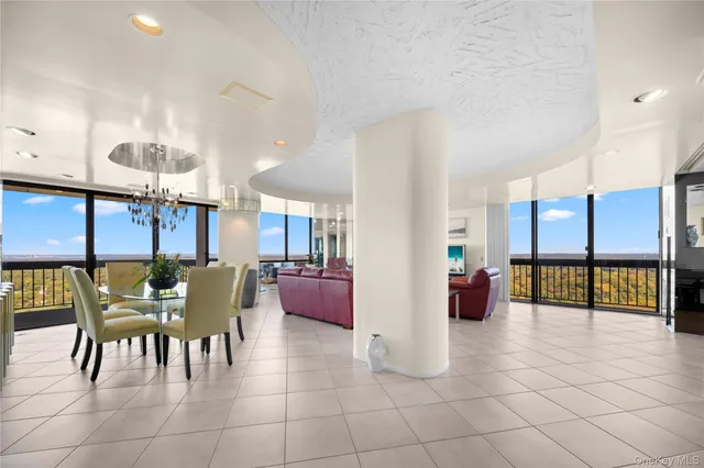 a living room with fireplace furniture and a large window