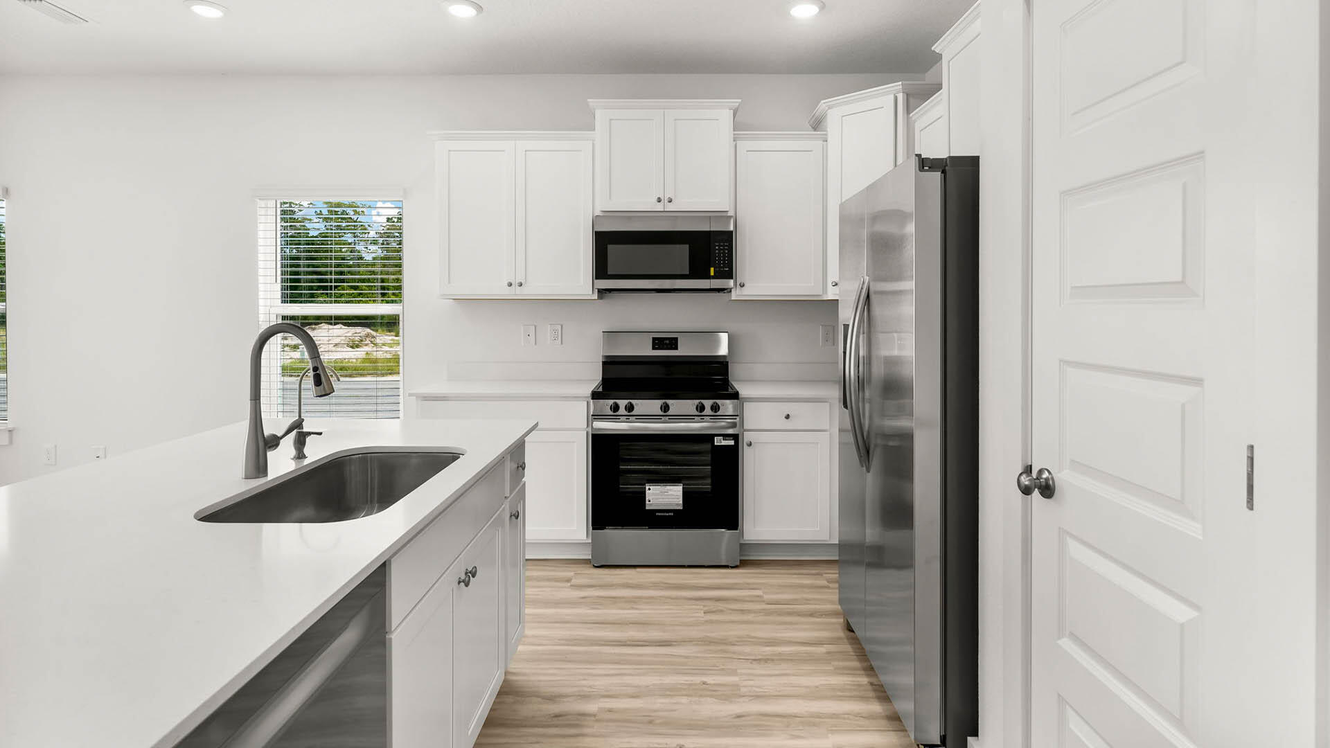 123 Hawk Street Santa Rosa Beach, FL 32459 - Photo 6 of 31 a kitchen with stainless steel appliances a stove a sink and a refrigerator