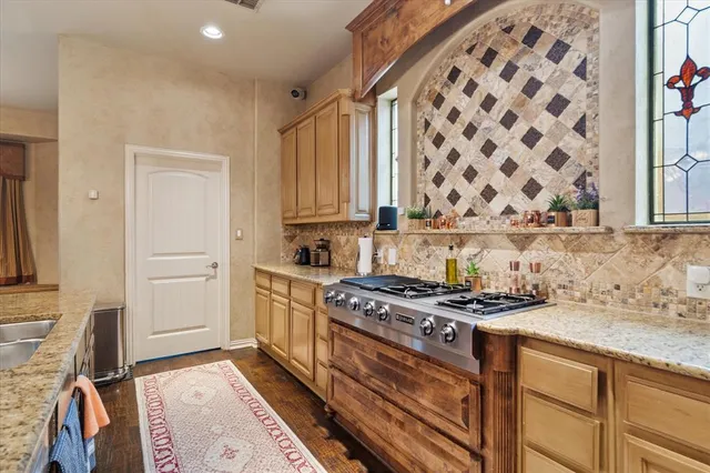 a kitchen with stainless steel appliances a stove and a refrigerator