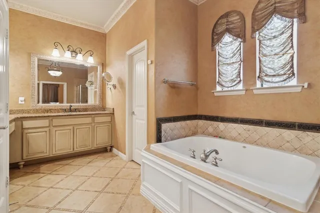 a bathroom with a tub sink and mirror