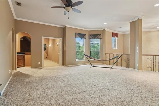 a view of an empty room with a fireplace and a window