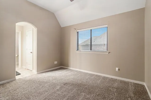 an empty room with closet and a bathroom