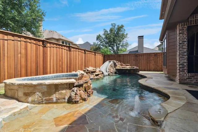 a view of a house with swimming pool and sitting area