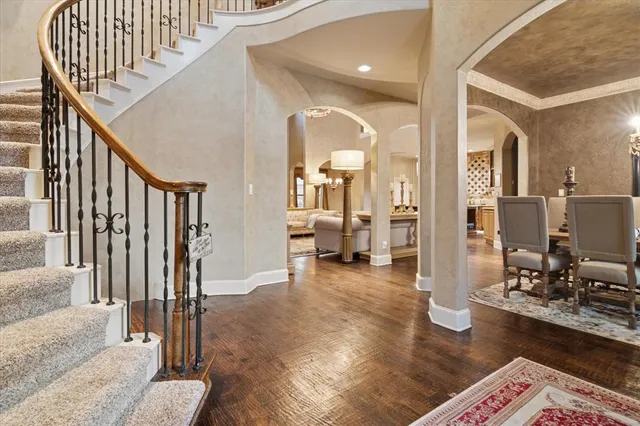 a view of a hallway with wooden floor and windows