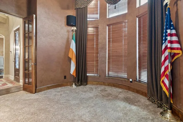 a view of an empty room with a fireplace and a window