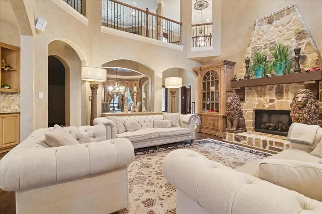 a living room with furniture fireplace and a large window