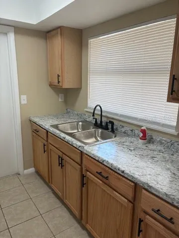 a kitchen with a sink a stove and cabinets