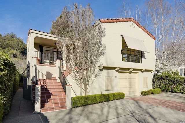 a view of a white building with large windows
