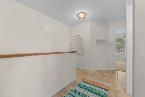 an empty room with a ceiling fan and window
