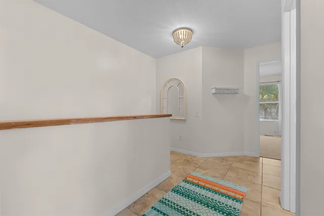 an empty room with a ceiling fan and window