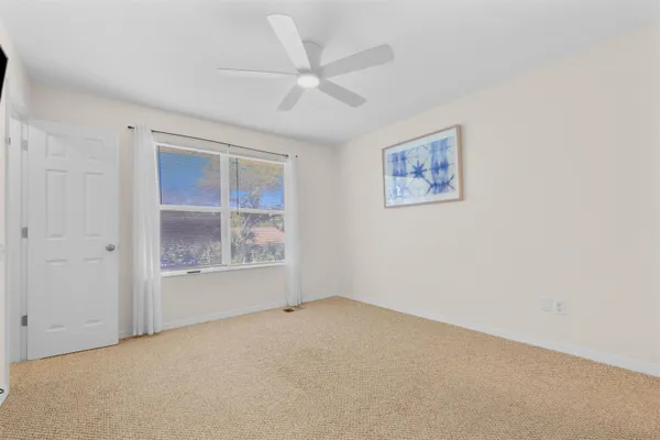 an empty room with windows and closet