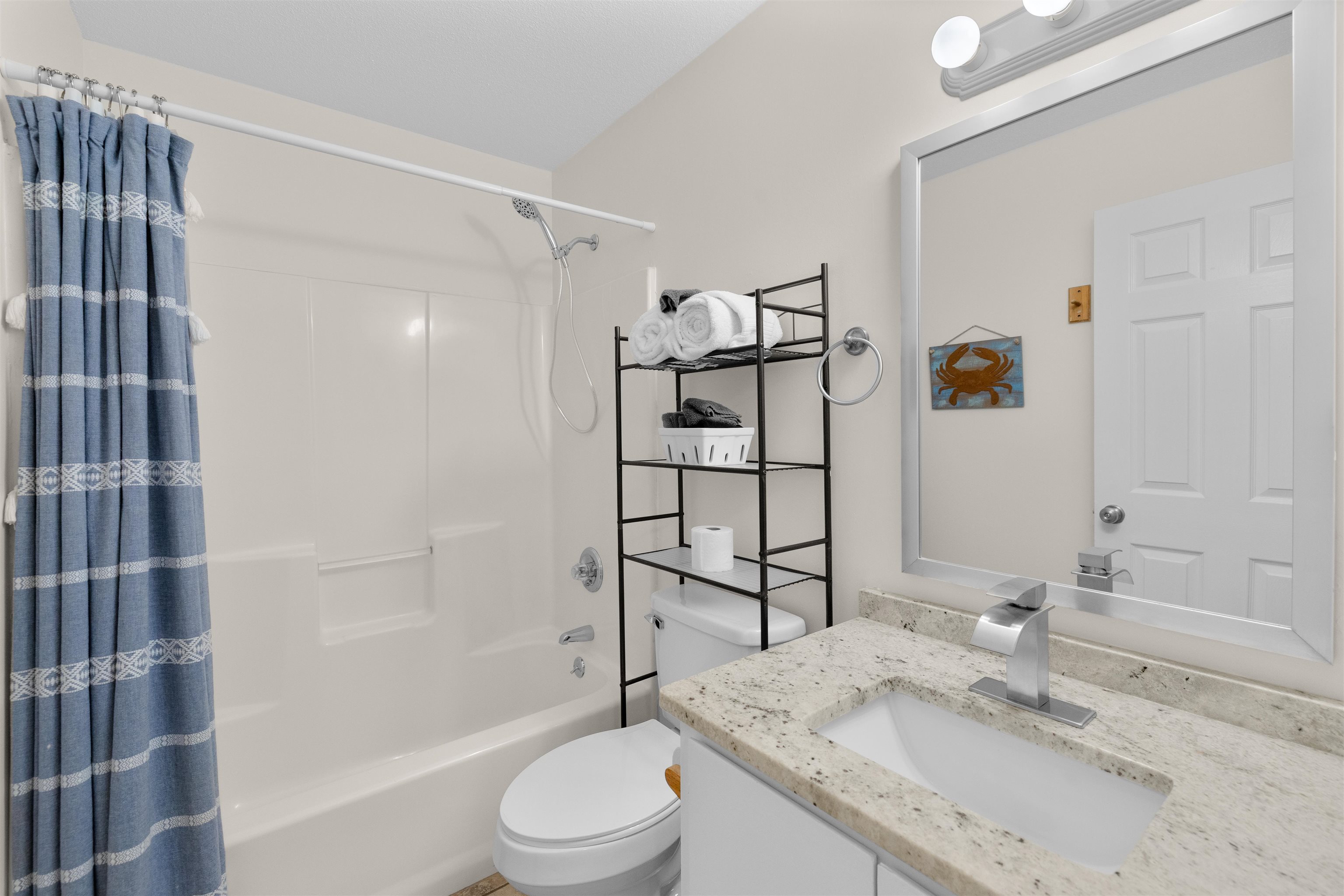 109 B Street, Unit D St. Augustine Beach, FL 32080 - Photo 21 of 29 a bathroom with a granite countertop sink toilet and shower