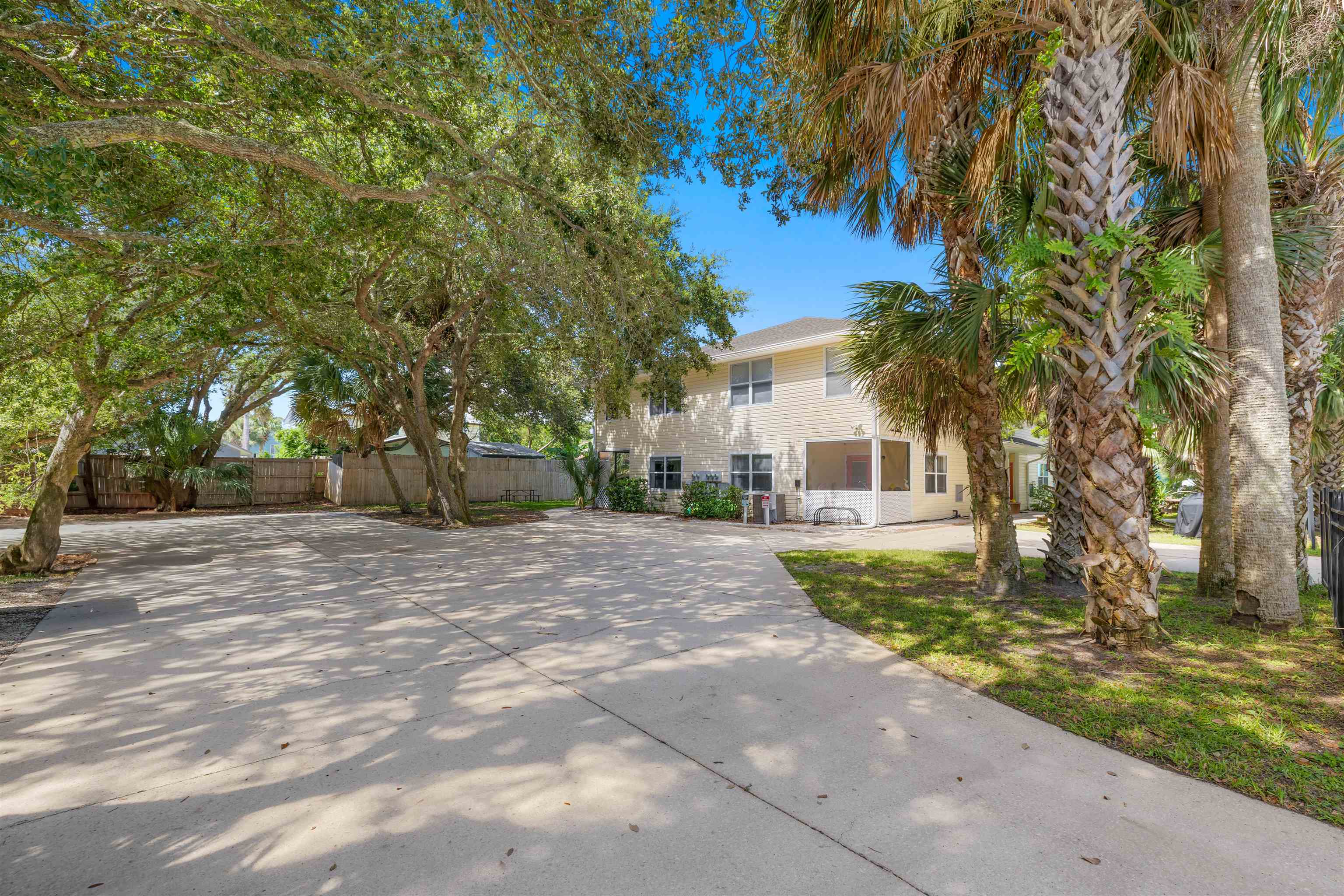 109 B Street, Unit D St. Augustine Beach, FL 32080 - Photo 24 of 29 a front view of a house with a yard and a garage