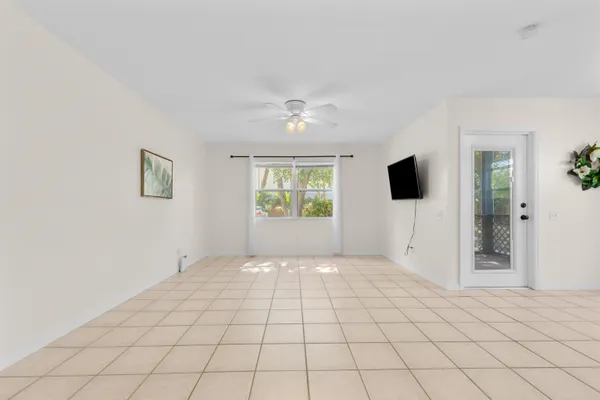 a view of a bedroom with a bed and a chandelier fan