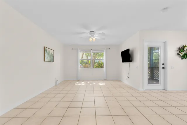 a view of a bedroom with a bed and a chandelier fan