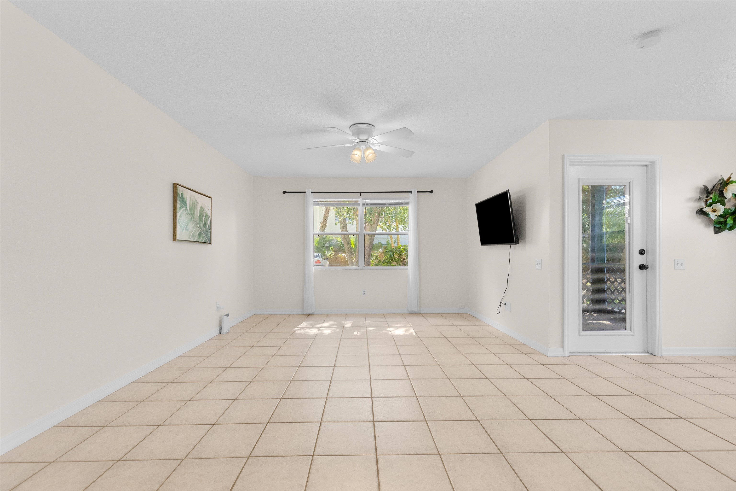 109 B Street, Unit D St. Augustine Beach, FL 32080 - Photo 4 of 29 a view of an empty room with a window and a kitchen