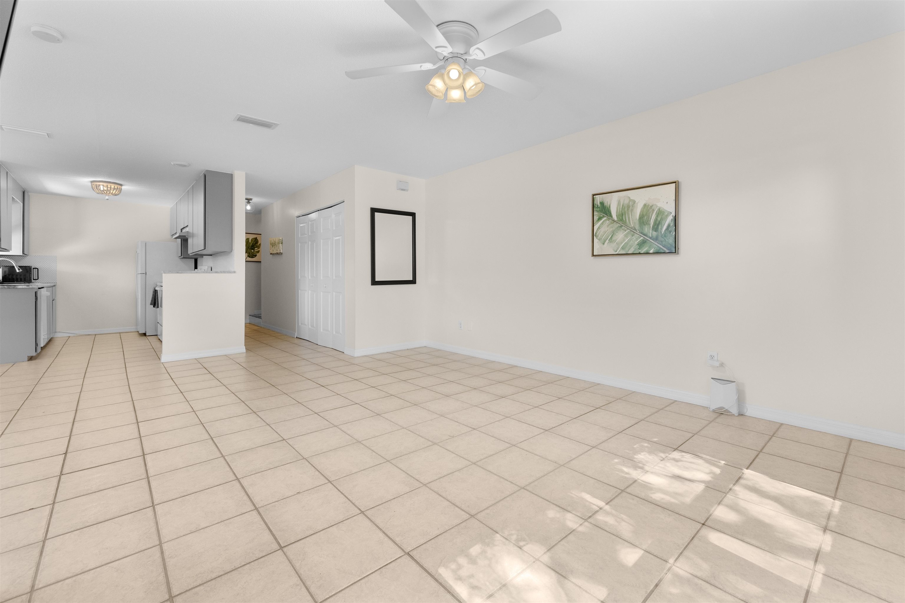 109 B Street, Unit D St. Augustine Beach, FL 32080 - Photo 5 of 29 a view of a bedroom with a bed and a chandelier fan