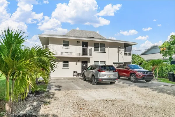 a car parked in front of white house