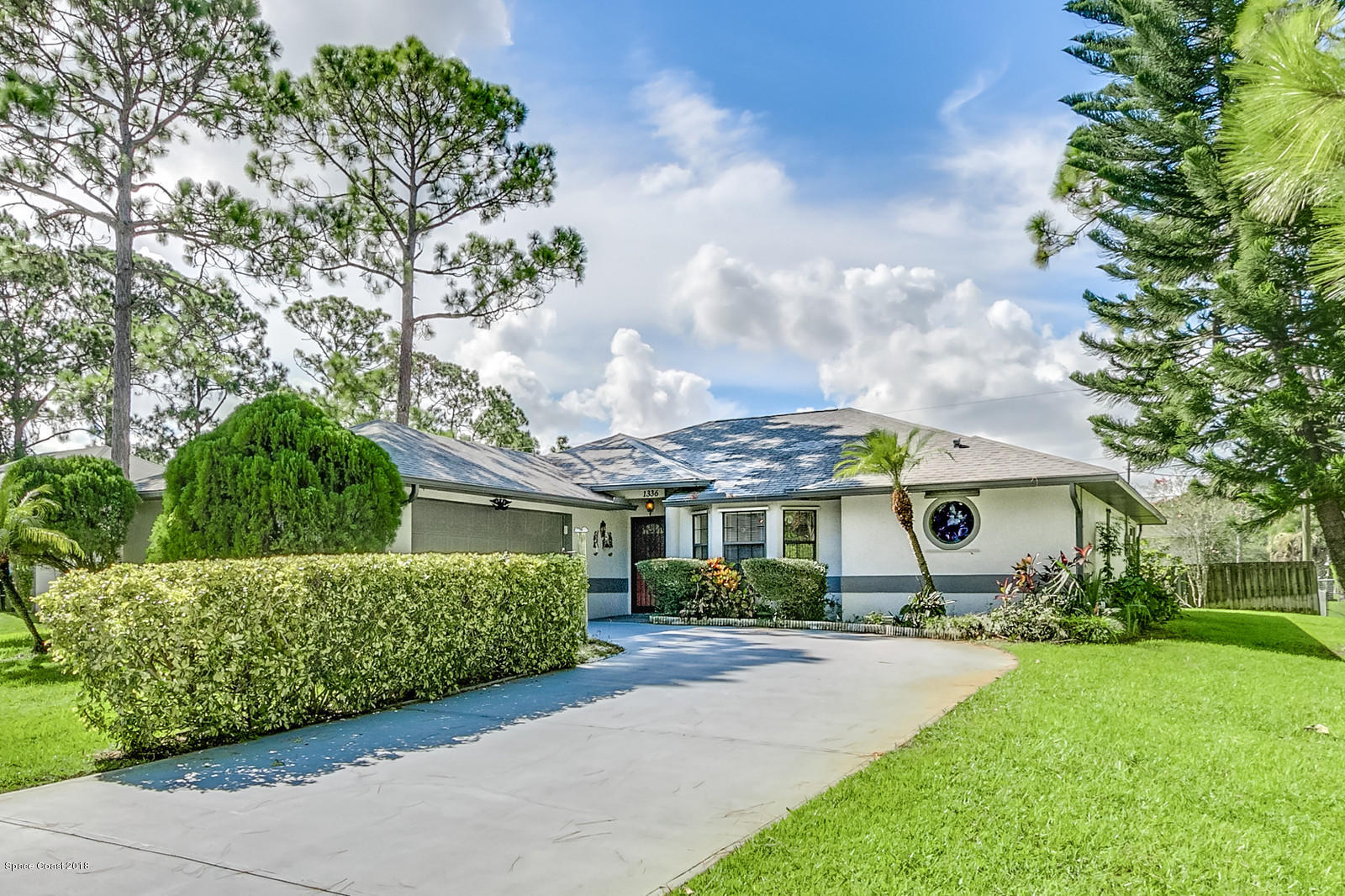 1336 Sapulpa Road Southwest Palm Bay, FL 32908 - Photo 1 of 25 a front view of a house with garden