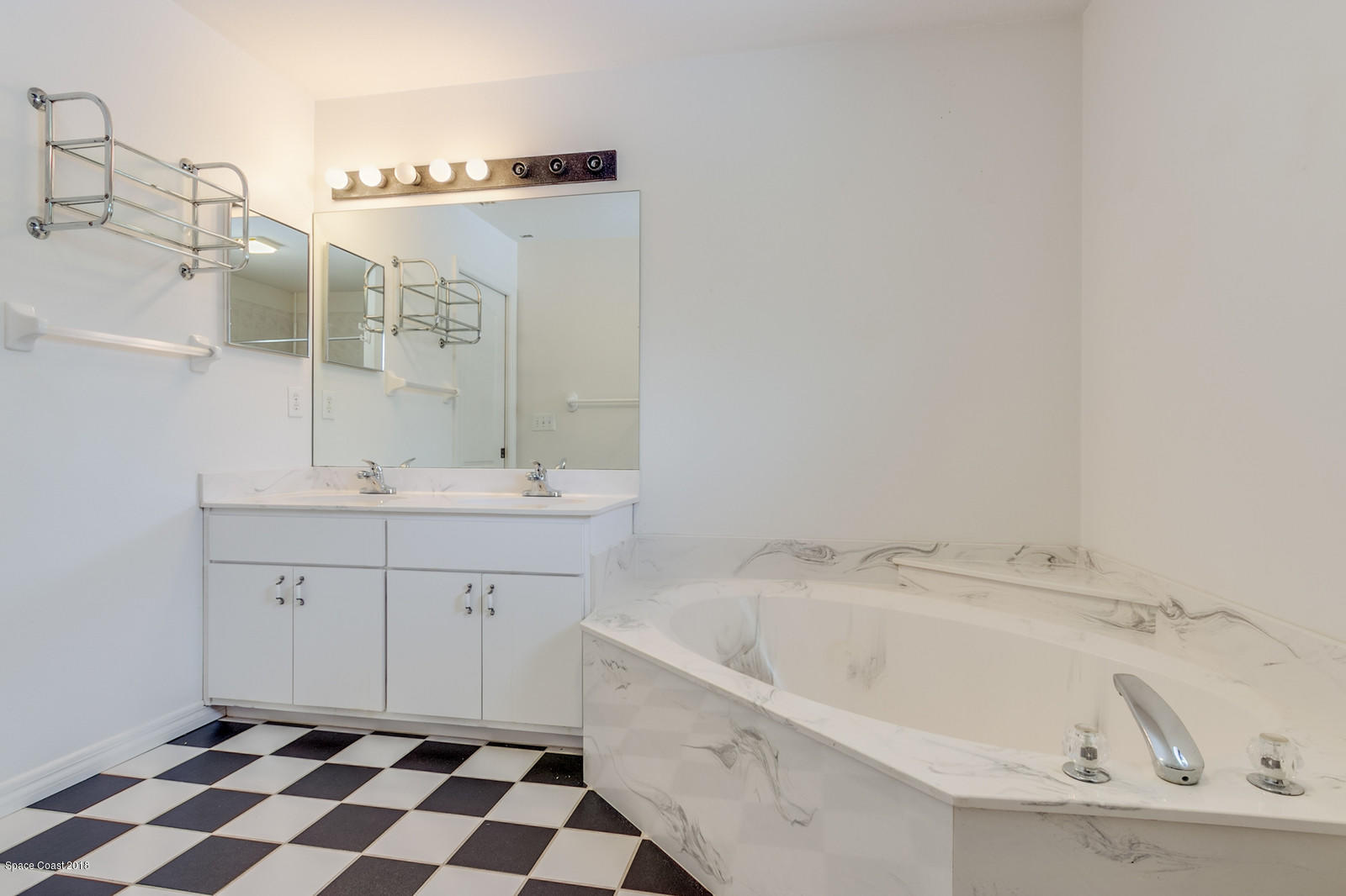 1336 Sapulpa Road Southwest Palm Bay, FL 32908 - Photo 15 of 25 a spacious bathroom with a sink and a mirror