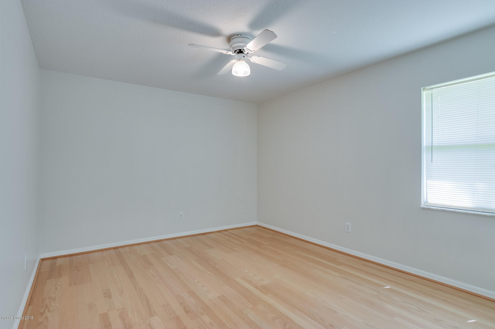 1336 Sapulpa Road Southwest Palm Bay, FL 32908 - Photo 16 of 25 an empty room with a window and a ceiling fan