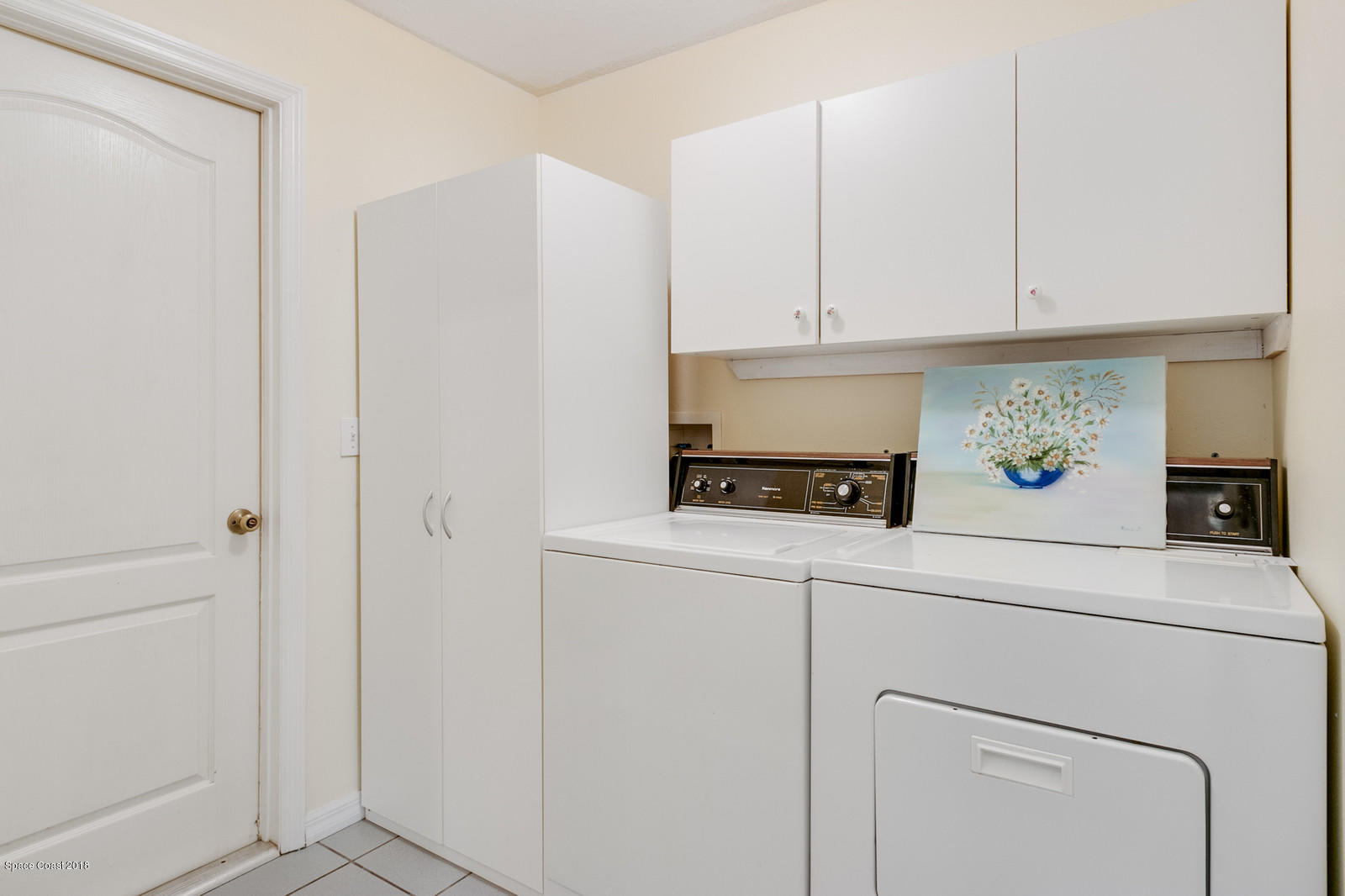 1336 Sapulpa Road Southwest Palm Bay, FL 32908 - Photo 19 of 25 a view of cabinets with washer and dryer