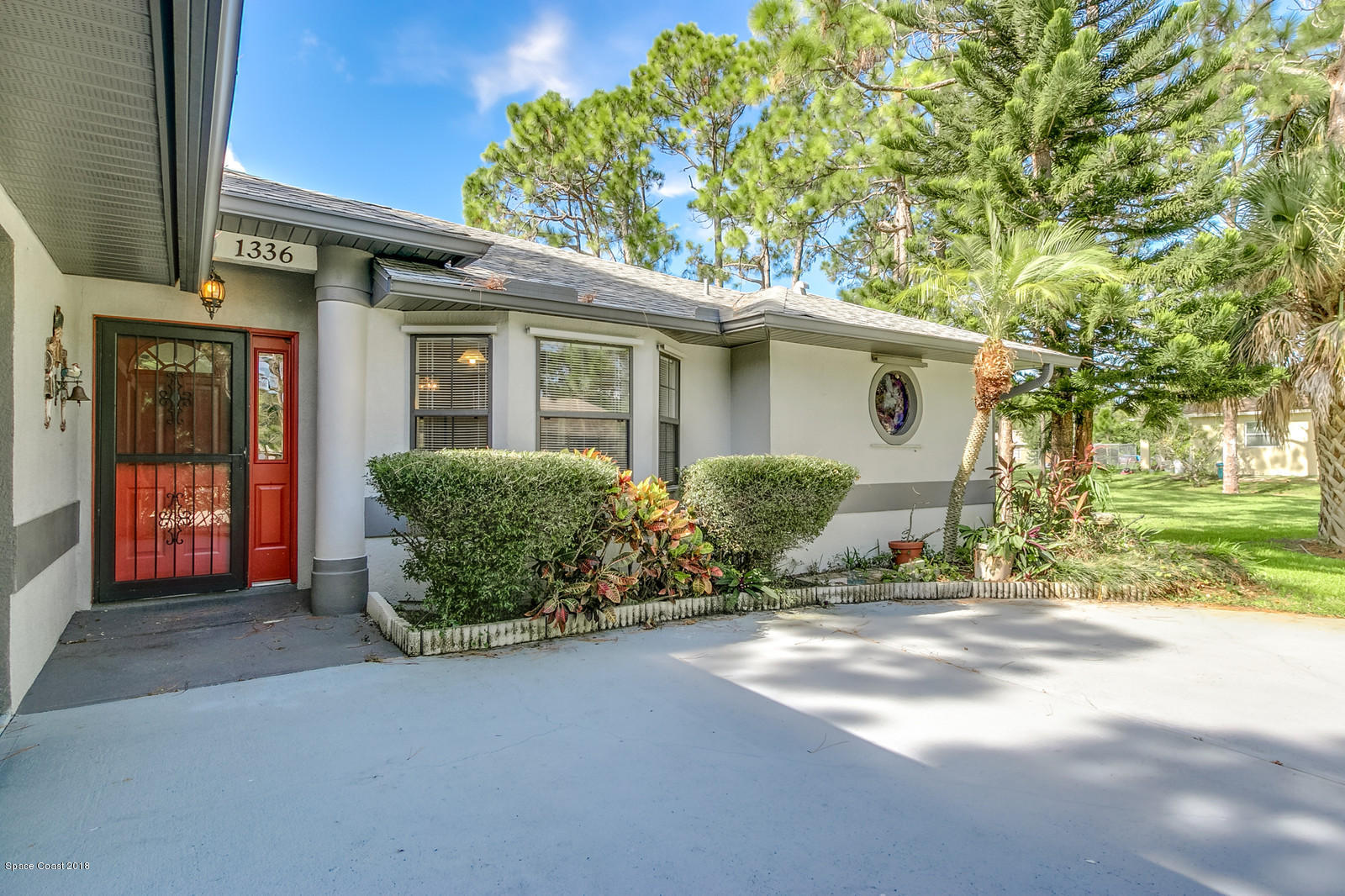 1336 Sapulpa Road Southwest Palm Bay, FL 32908 - Photo 3 of 25 a view of a house with a garden