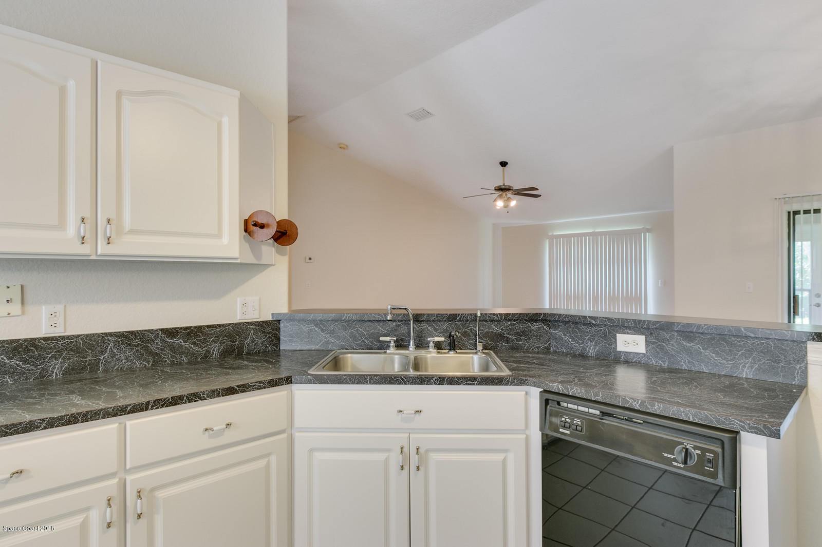 1336 Sapulpa Road Southwest Palm Bay, FL 32908 - Photo 9 of 25 a kitchen with granite countertop white cabinets and a sink