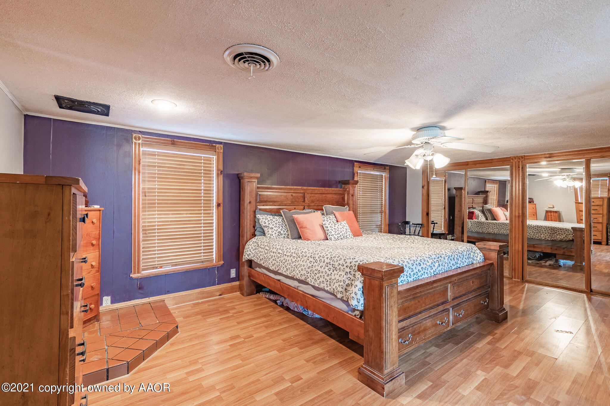 105 Southwest 41st Avenue Amarillo, TX 79110 - Photo 18 of 27 a bedroom with a large bed and a chandelier