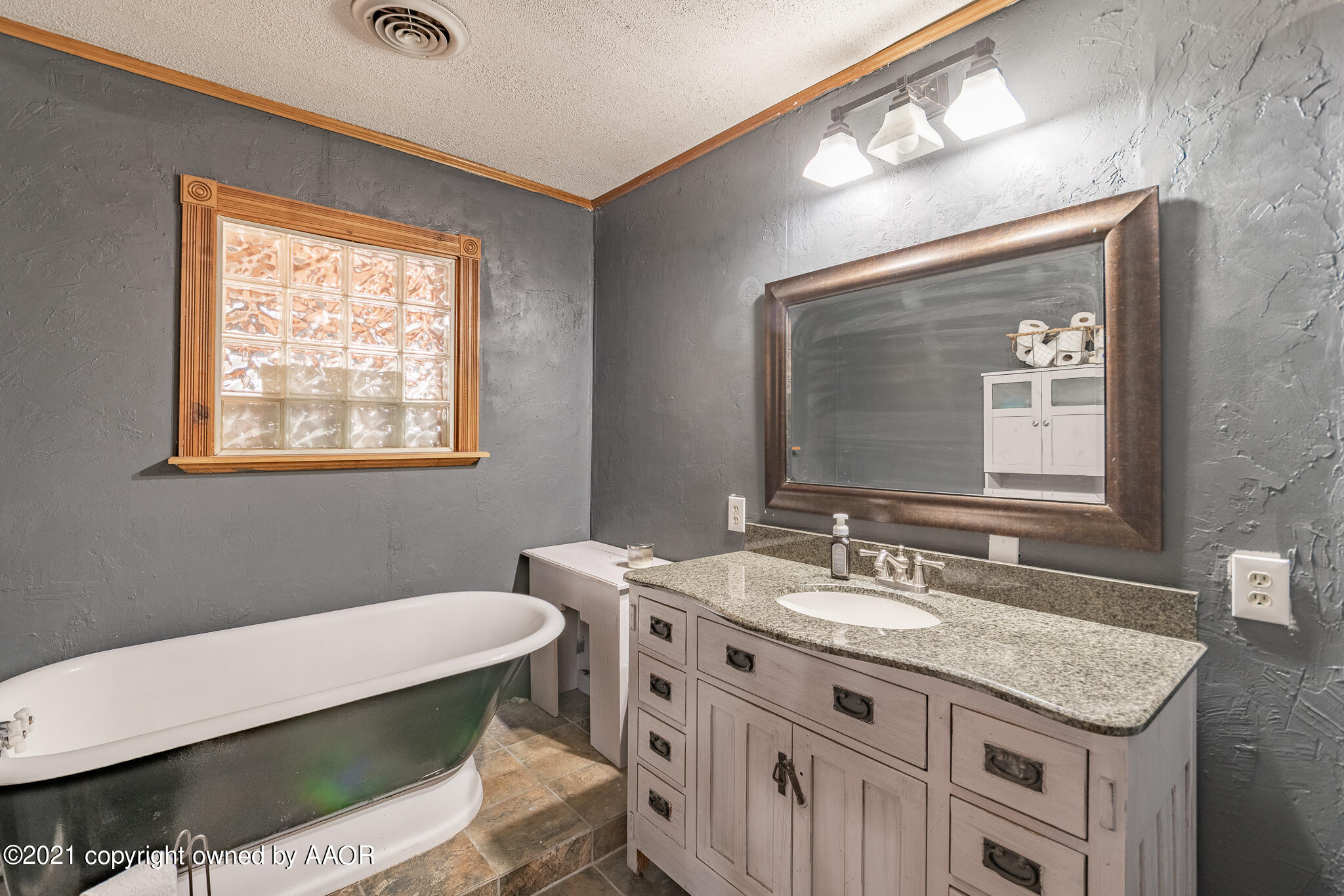 105 Southwest 41st Avenue Amarillo, TX 79110 - Photo 19 of 27 a bathroom with a granite countertop sink a toilet and mirror