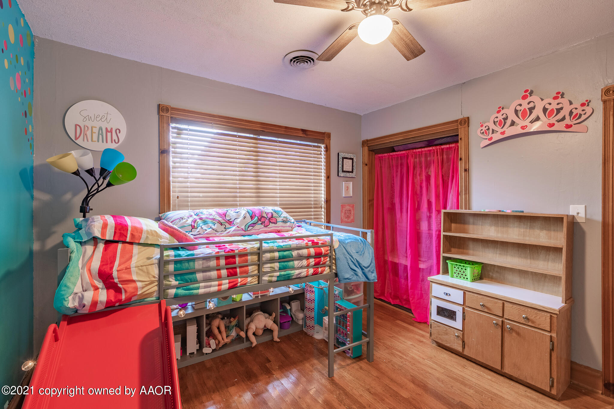 105 Southwest 41st Avenue Amarillo, TX 79110 - Photo 21 of 27 a bedroom with a bed and a chandelier