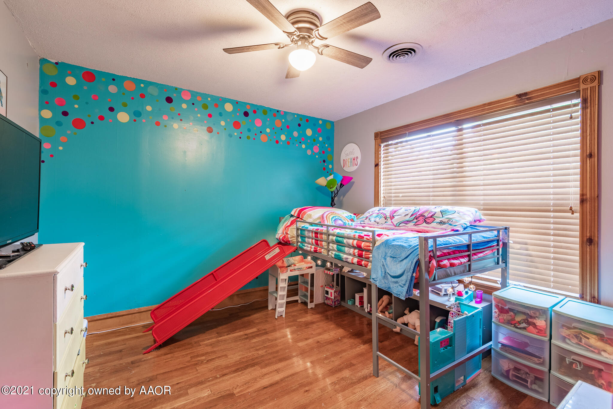 105 Southwest 41st Avenue Amarillo, TX 79110 - Photo 22 of 27 a bedroom with a bed and a chandelier