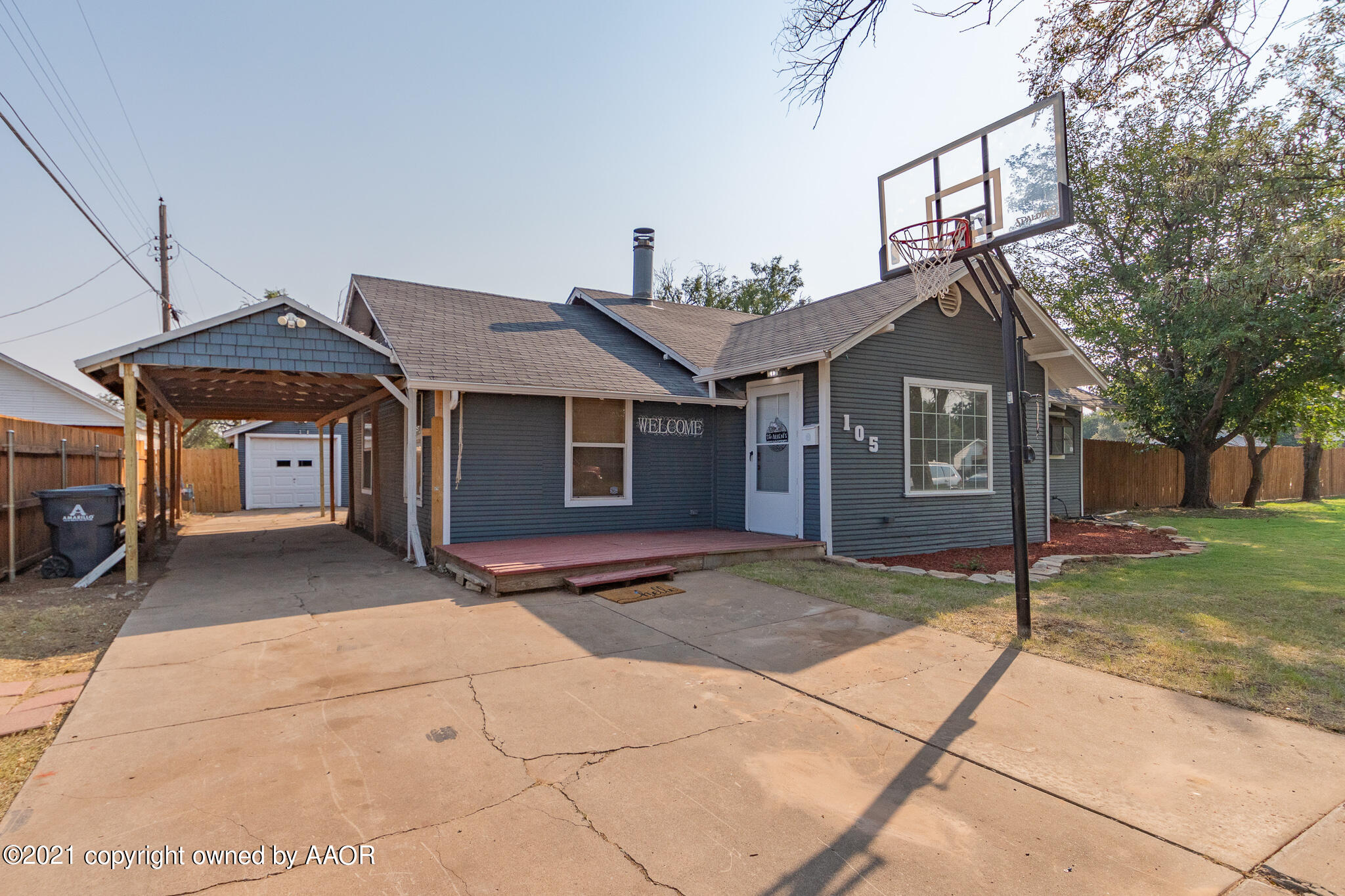 105 Southwest 41st Avenue Amarillo, TX 79110 - Photo 3 of 27 a front view of a house with a yard and garage