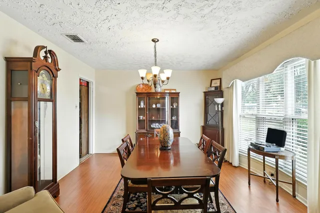 a view of a dining room with furniture window and wooden floor
