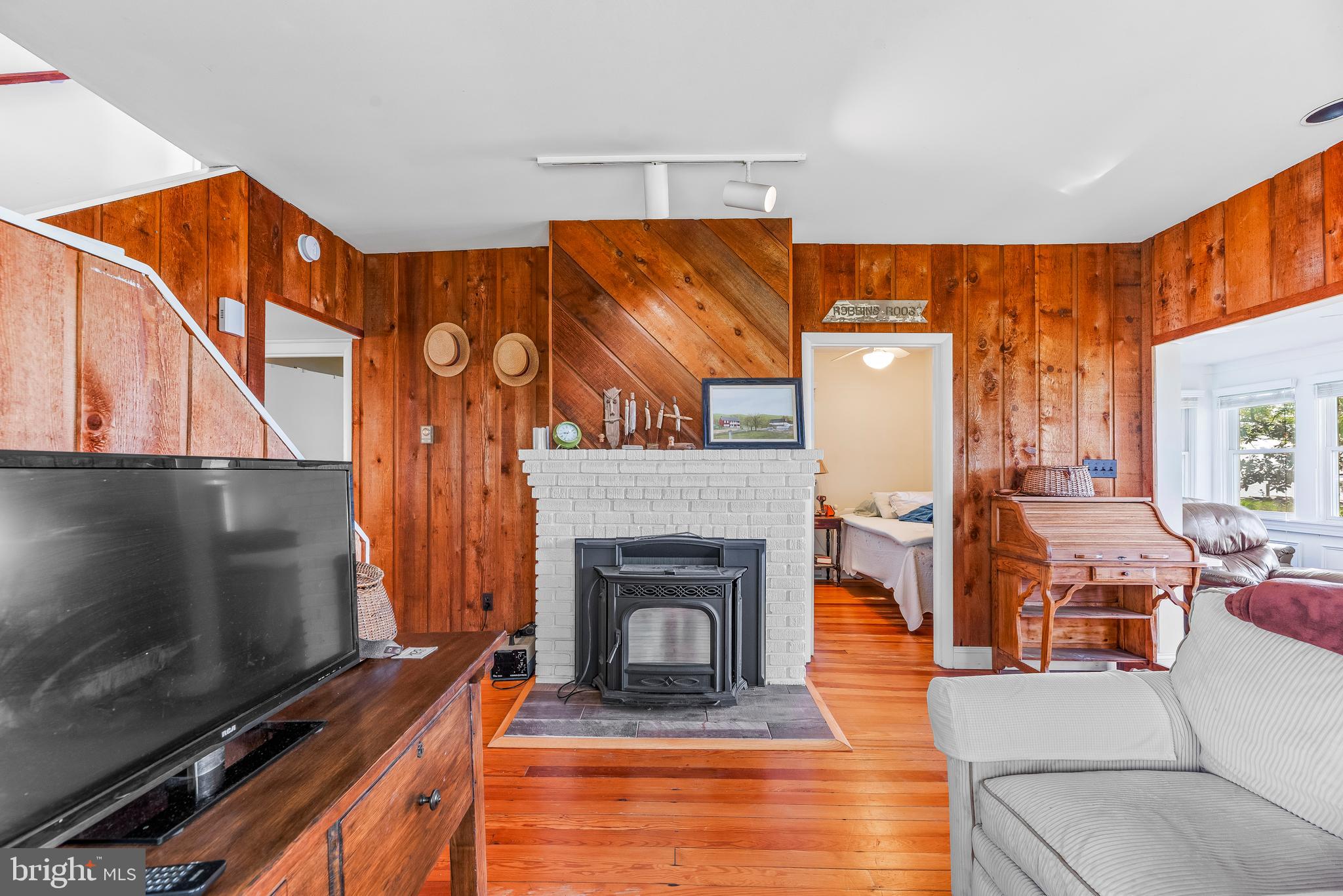 4749 Oak Road Shady Side, MD 20764 - Photo 28 of 51 Image cozying up to the warmth of the pellet stove