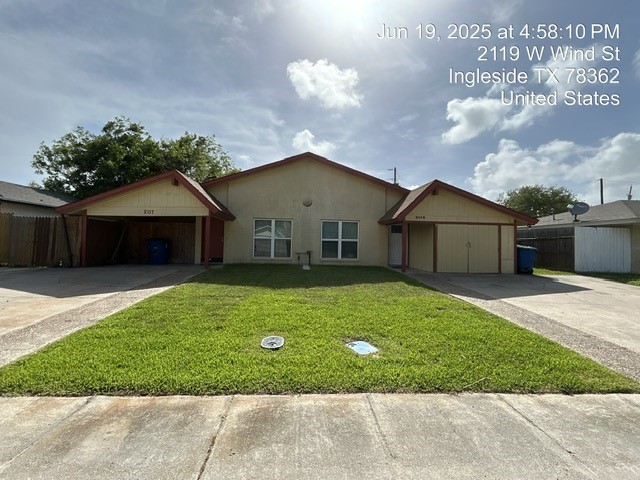 2119 Westwind Circle, Unit 2 Ingleside, TX 78362 - Photo 1 of 16 a front view of a house with a garden