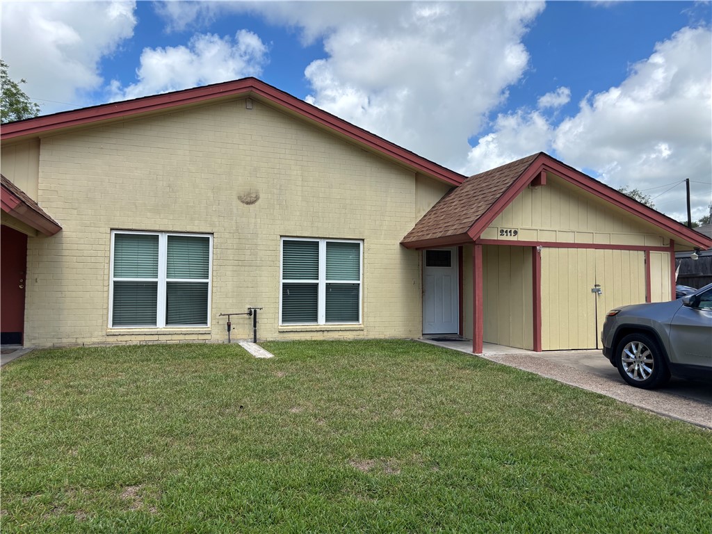 2119 Westwind Circle, Unit 2 Ingleside, TX 78362 - Photo 2 of 16 a front view of a house with a garden and pathway