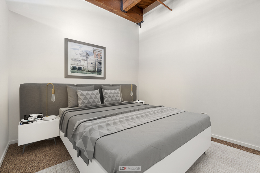 1040 West Adams Street, Unit 247 Chicago, IL 60607 - Photo 13 of 20 a bedroom with a bed and a couch