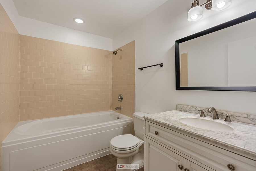 1040 West Adams Street, Unit 247 Chicago, IL 60607 - Photo 14 of 20 a bathroom with a granite countertop sink toilet and shower