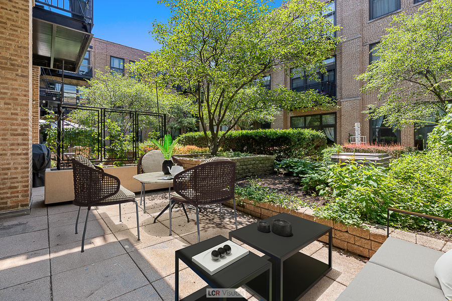 1040 West Adams Street, Unit 247 Chicago, IL 60607 - Photo 16 of 20 a view of a patio with table and chairs and potted plants
