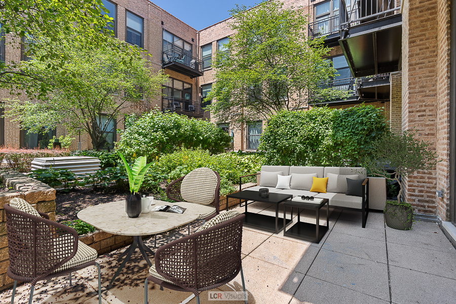 1040 West Adams Street, Unit 247 Chicago, IL 60607 - Photo 19 of 20 a view of a patio with couches table and chairs and potted plants