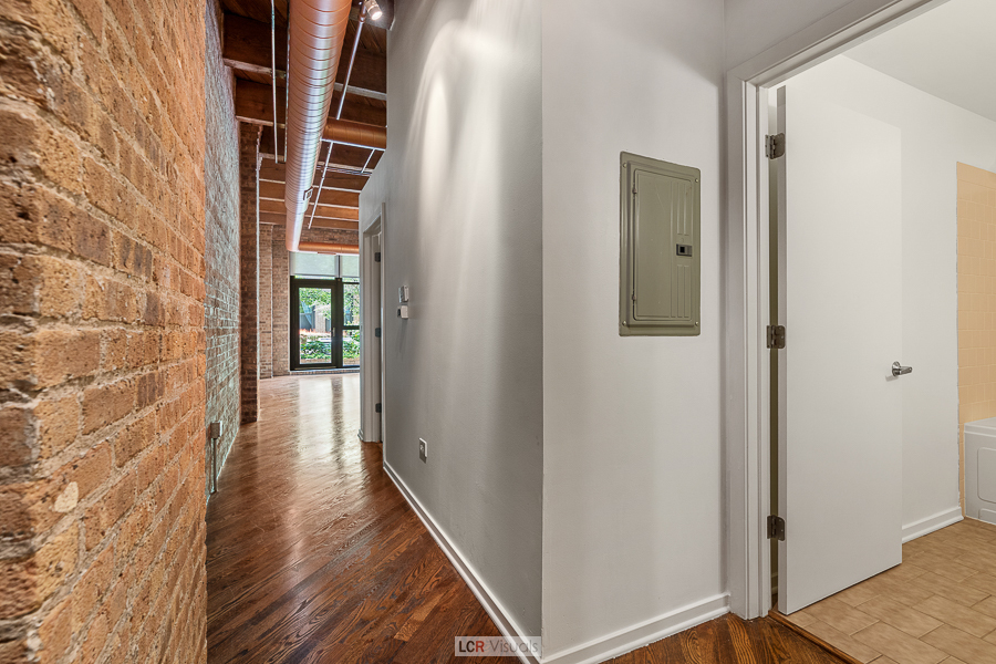 1040 West Adams Street, Unit 247 Chicago, IL 60607 - Photo 2 of 20 a view of a hallway with wooden floor and entryway