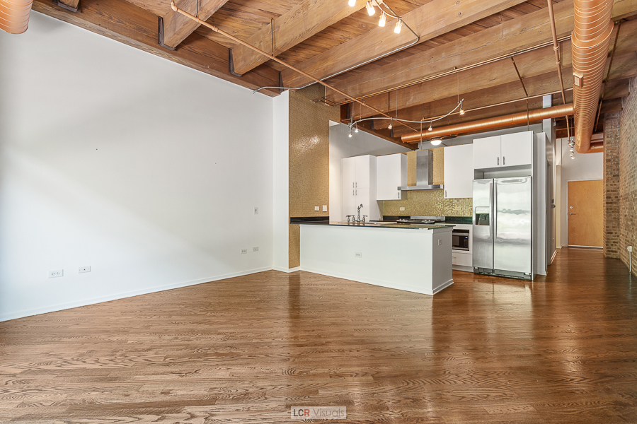 1040 West Adams Street, Unit 247 Chicago, IL 60607 - Photo 3 of 20 a view of a kitchen with a sink and a refrigerator