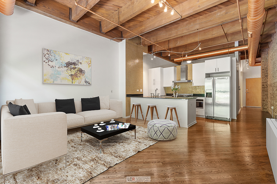 1040 West Adams Street, Unit 247 Chicago, IL 60607 - Photo 4 of 20 a living room with furniture and kitchen view