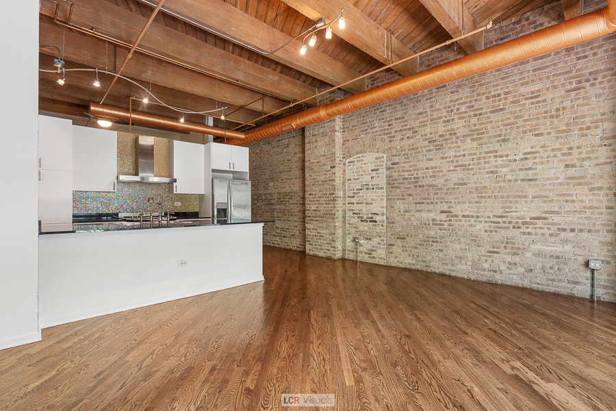 1040 West Adams Street, Unit 247 Chicago, IL 60607 - Photo 5 of 20 a view of empty room with wooden floor